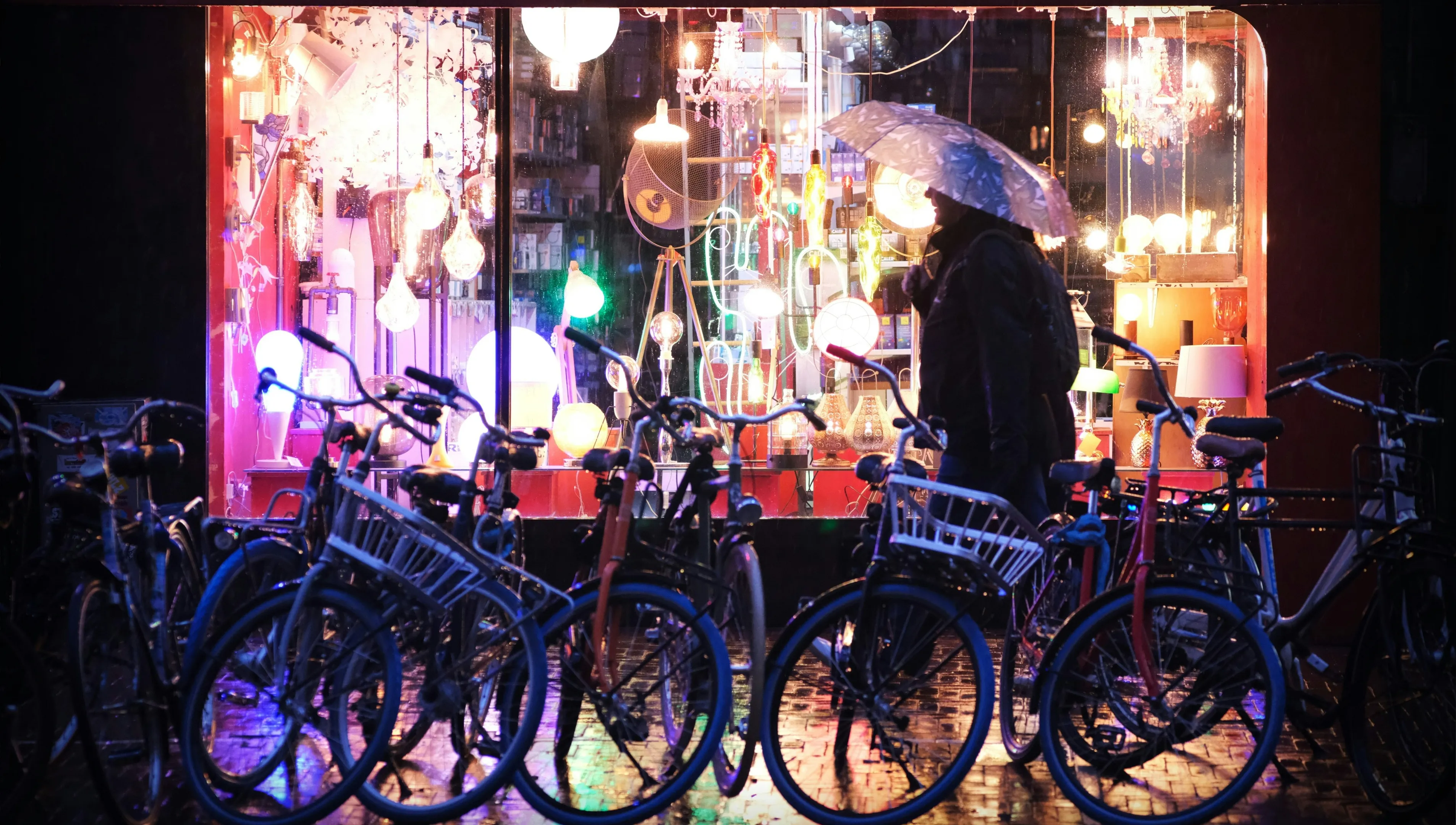 man in rain by bikes