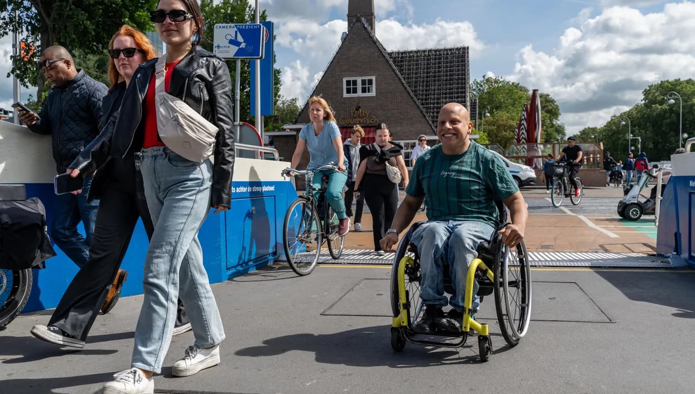 A person in a wheelchair taking the ferry.