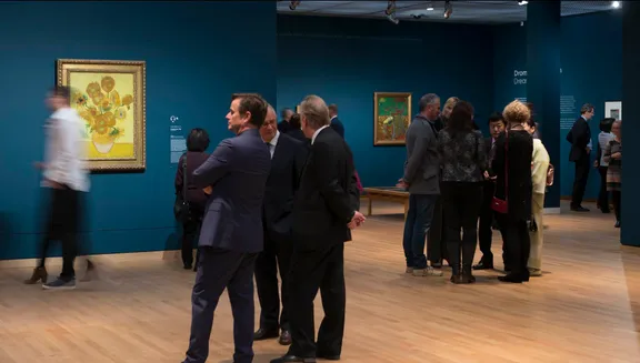 Visitors in the museum close to the famous "Zonnebloemen" painting from Vincent van Gogh.