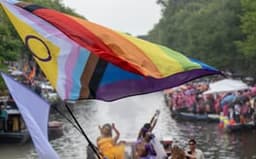 Big rainbow flag during the Canal Parade of Amsterdam Pride 2025.