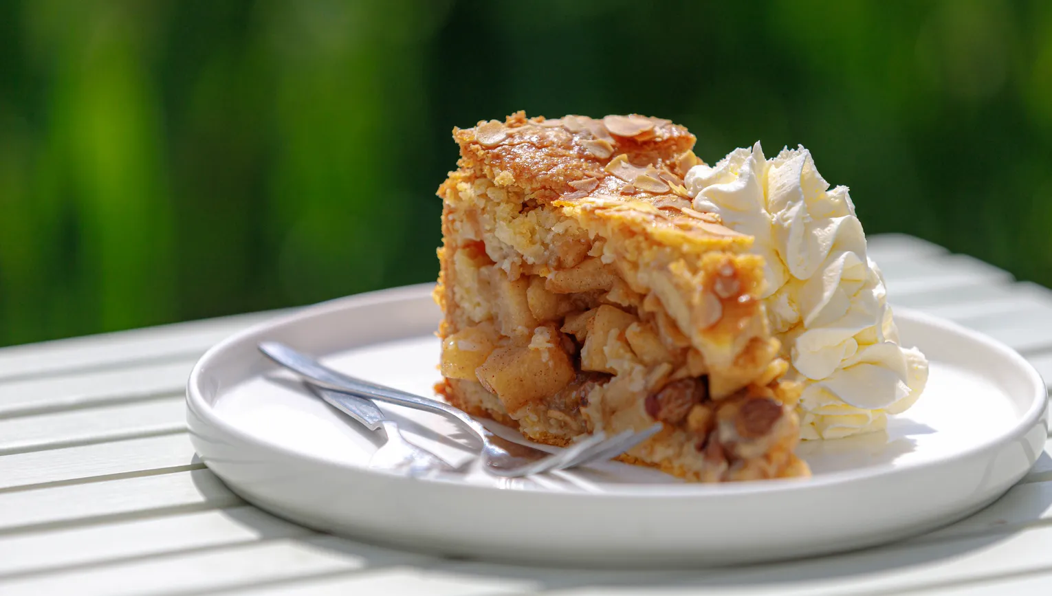 Selective focus of a piece of apple pie on white plate served with whipping cream on the side, Homemade apple pie on wooden table with blurred green garden background.
1787711810
Typically Dutch foods