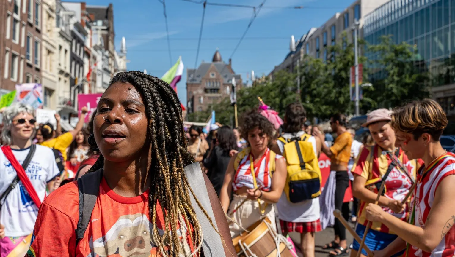A crowd of people marching - Pride Walk Amsterdam