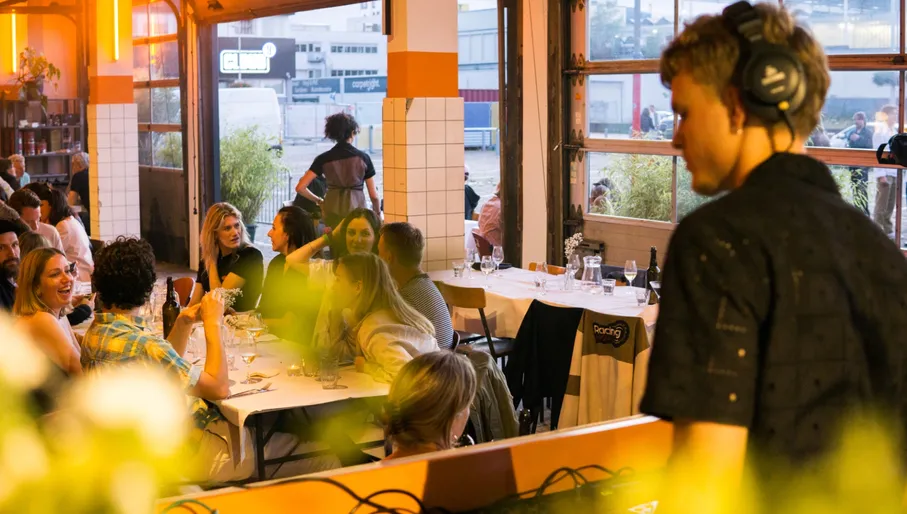 Bar Dancing Multipla DJ playing music while people having dinner