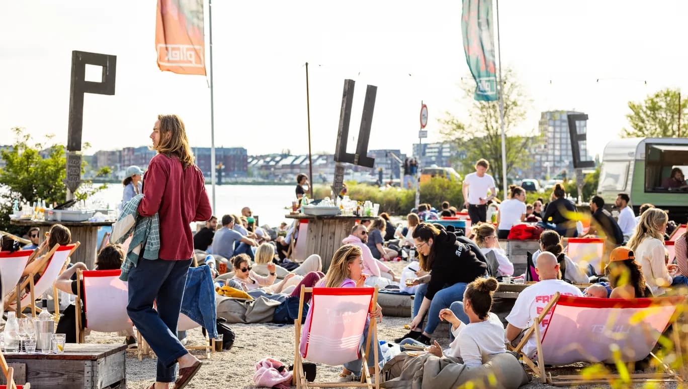 People chilling on the city beach of Pllek