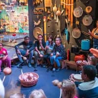 Group of children in a circle during the exhibition Sabi Suriname in the Tropenmuseum during 24H Oost 2019