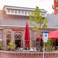 People sitting Outside Poesiat en Kater Oost