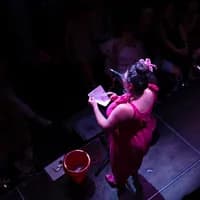 Comedian on stage at De Nieuwe Anita for Smut Slam queer comedy night