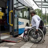 A person in a wheelchair enters the bus.
