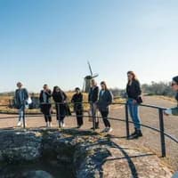 A group of people taking a tour of the Fort van Hoofddorp