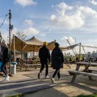A couple is walking onto the terrace of café-restaurant and cultural hotspot Noorderlicht at NDSM.