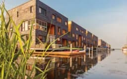 Row of Dutch modern canal houses in Almere reflected in the water