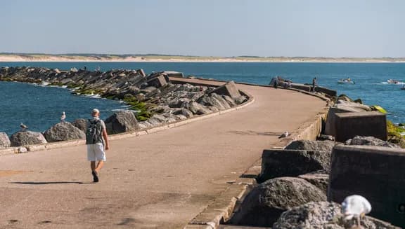A man walking over Zuidpier IJmuiden.