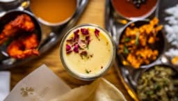 Thali of dishes and lassi drink at The Madras Diaries Indian resturant