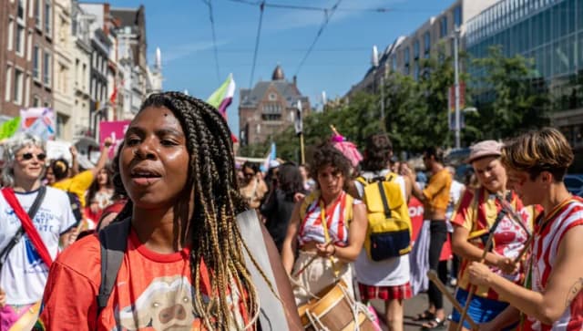 A crowd of people marching - Pride Walk Amsterdam