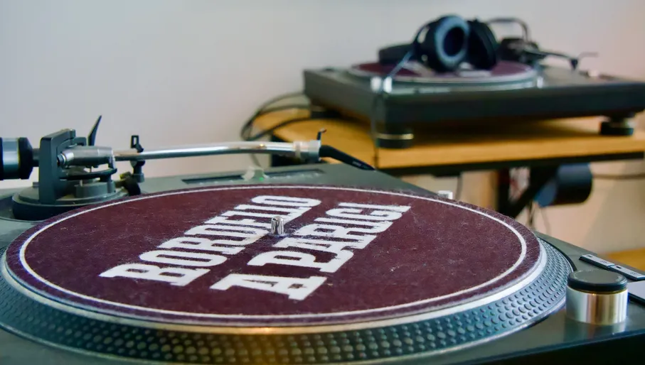 outside of shop with sign and building, outside of shop with sign and a man, inside of shop with records and record players