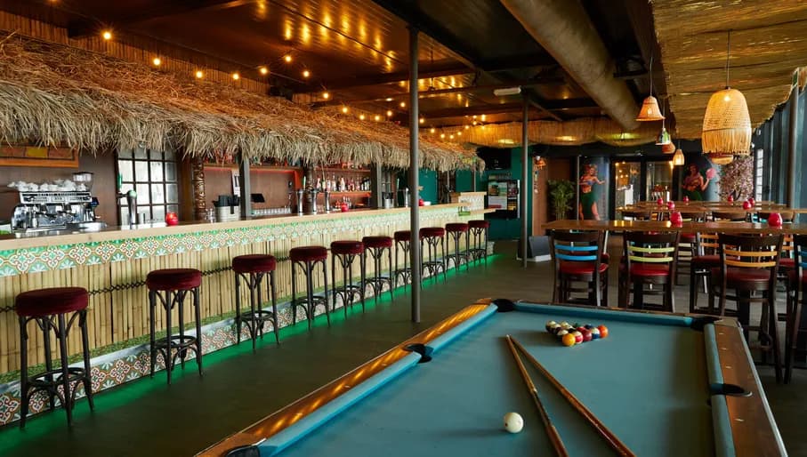 Aloha game center, Hawaii themed interior with bar and pool table