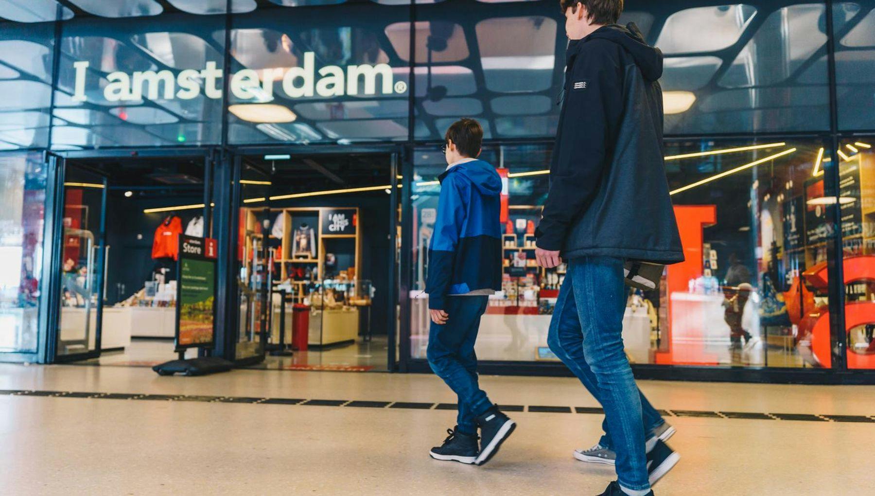 Two boys about to enter the Iamsterdam Store at Amsterdam Central Station.