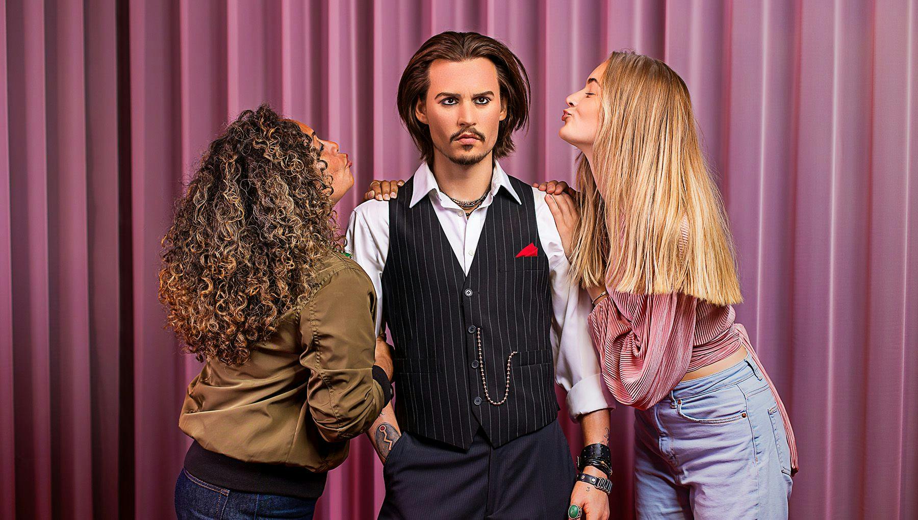 Madame Tussauds women posing with Johnny Depp
