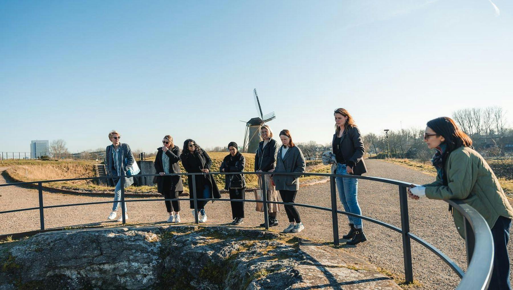A group of people taking a tour of the Fort van Hoofddorp