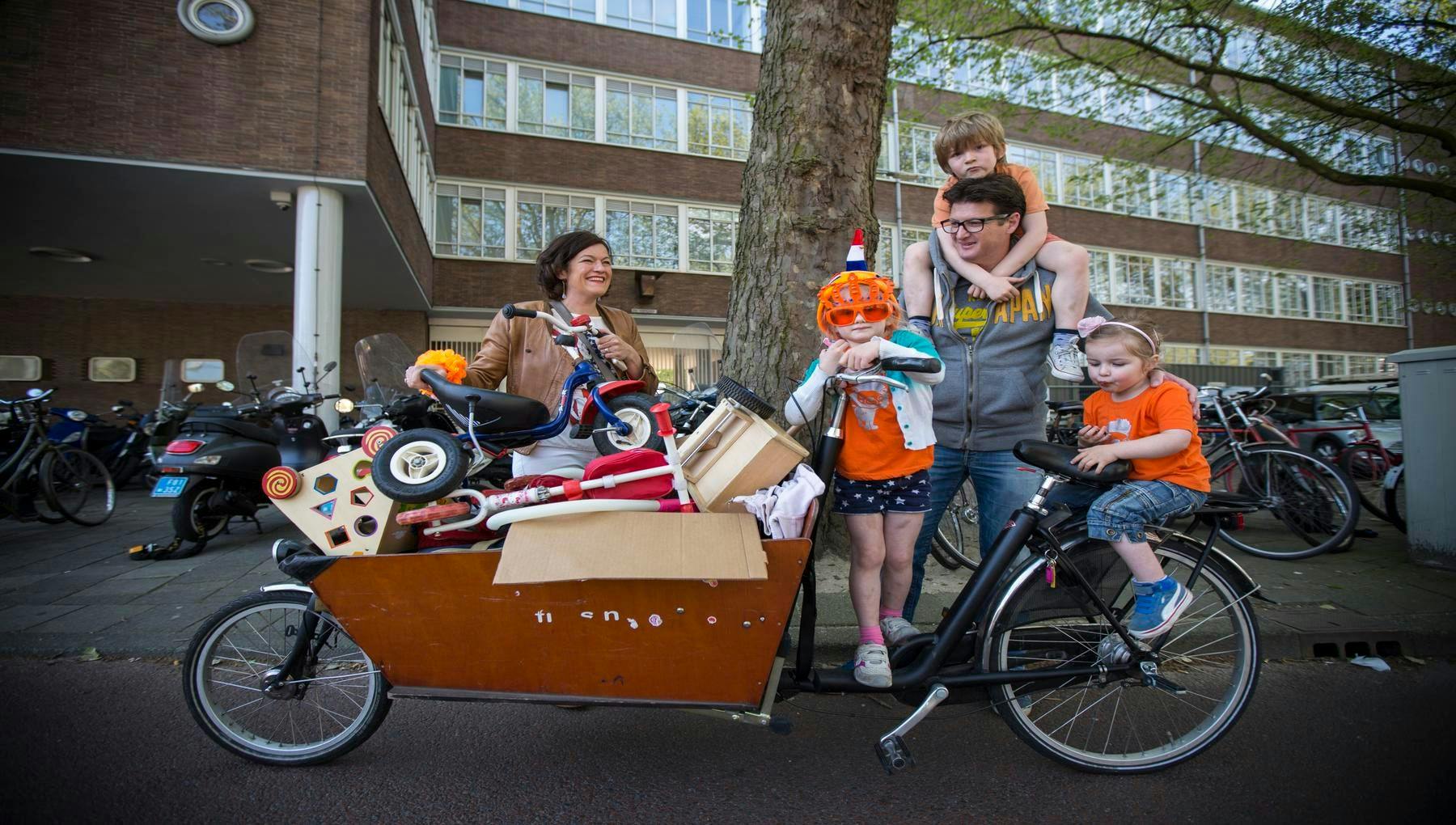 Koningsdag or King's Day is a national holiday in the Kingdom of the Netherlands. Celebrated on 27 April, the date marks the birth of King Willem-Alexander. 

Celebrations: Kings day family with a cargo bike wearing orange costumes, flea markets.