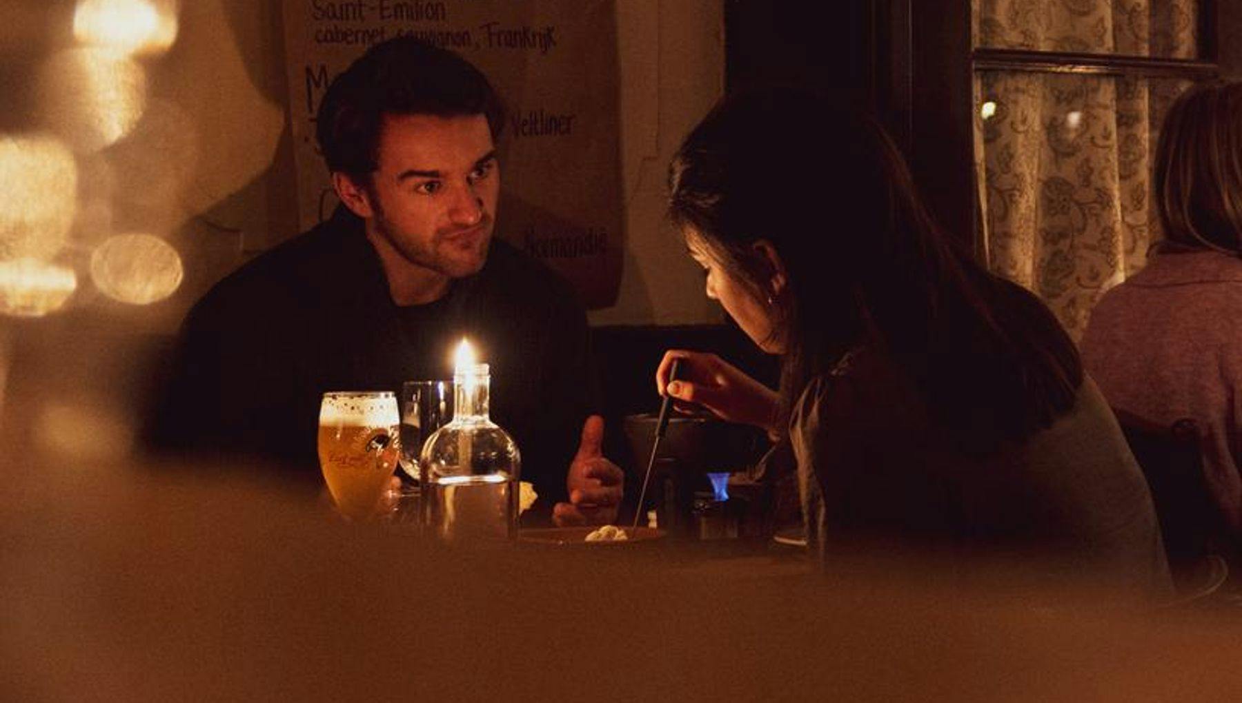 Couple dining in romantic candlelight at Smelt cheese fondue restaurant
