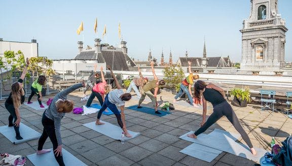 Upon the roof yoga session on De Bijenkorf, a luxury department store. 24H Centrum.