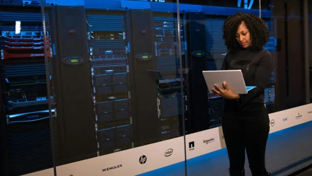 lady in front of large computing system with laptop
