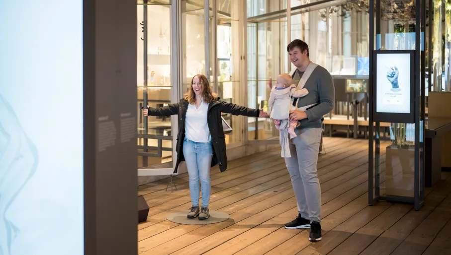 Parents with baby visiting the exhibition at Artis Groote Museum