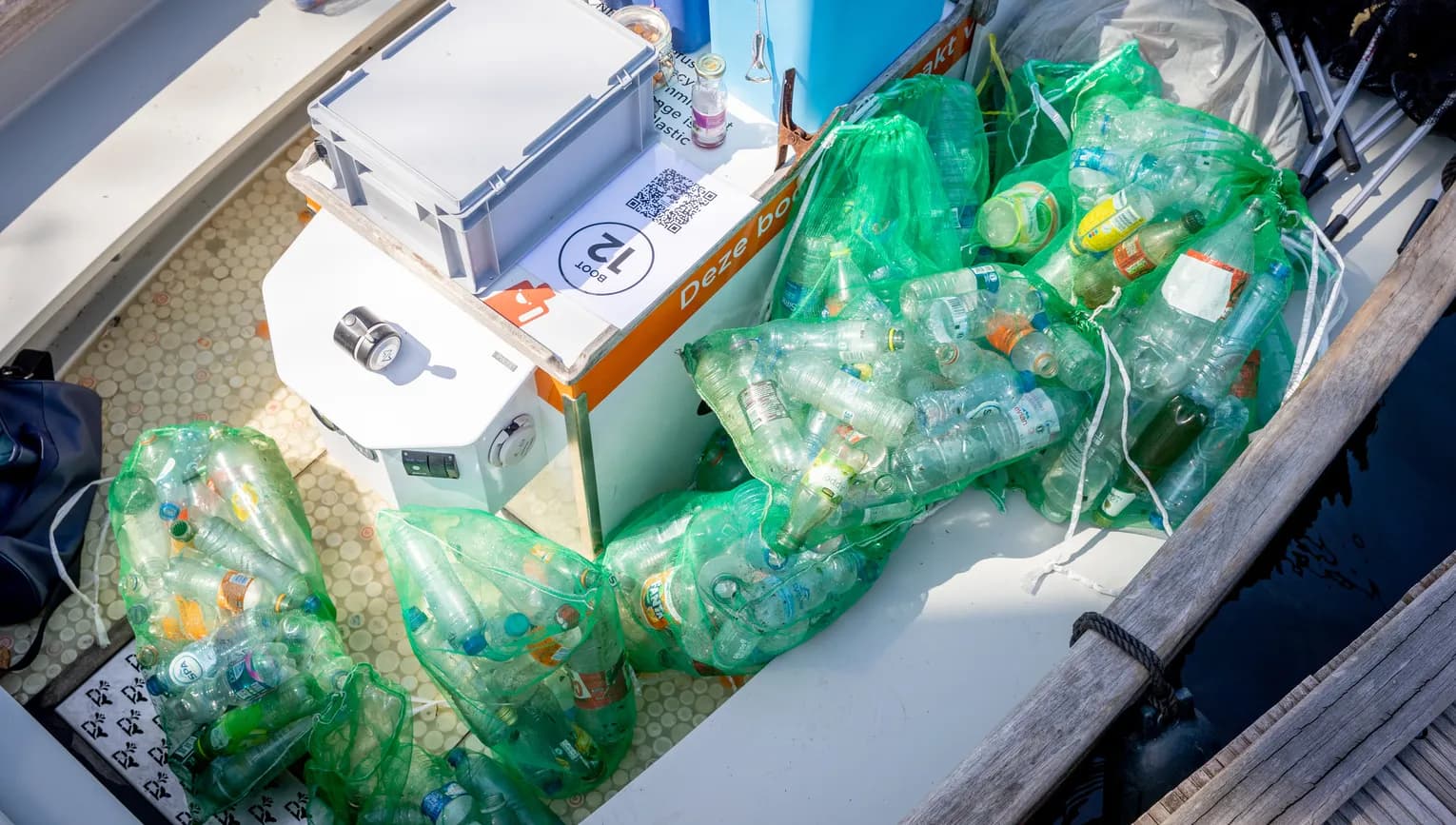 Rubbish and junk coWastePlastic Whale boat with volunteers