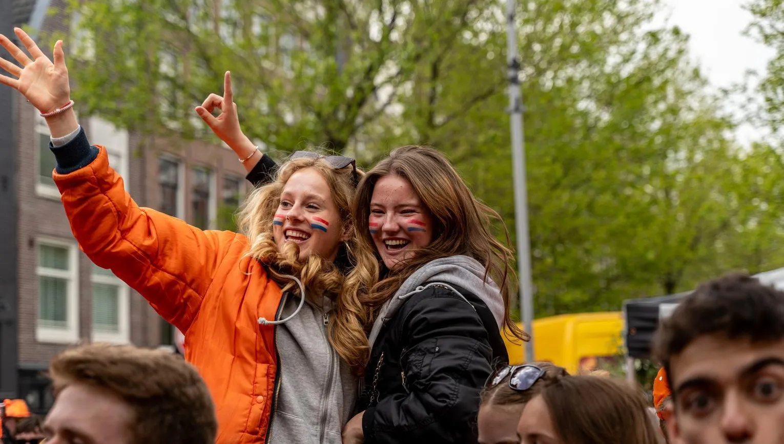 Two girls at Elandsgracht celebrating King's Day 2024.