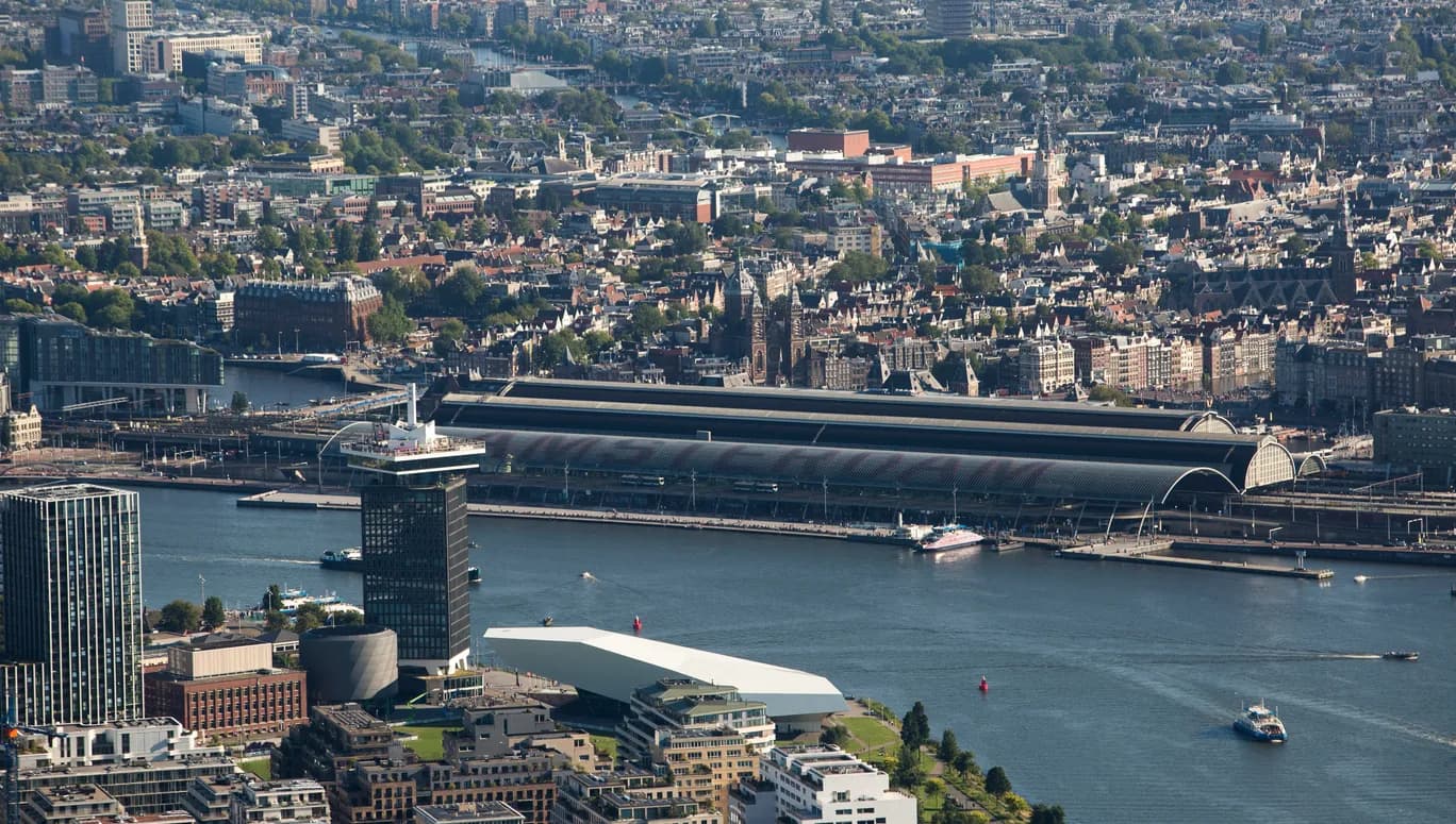 Aerial view on Noord and City Centre: Amsterdam Centraal, A'DAM Tower and EYE Filmmuseum.