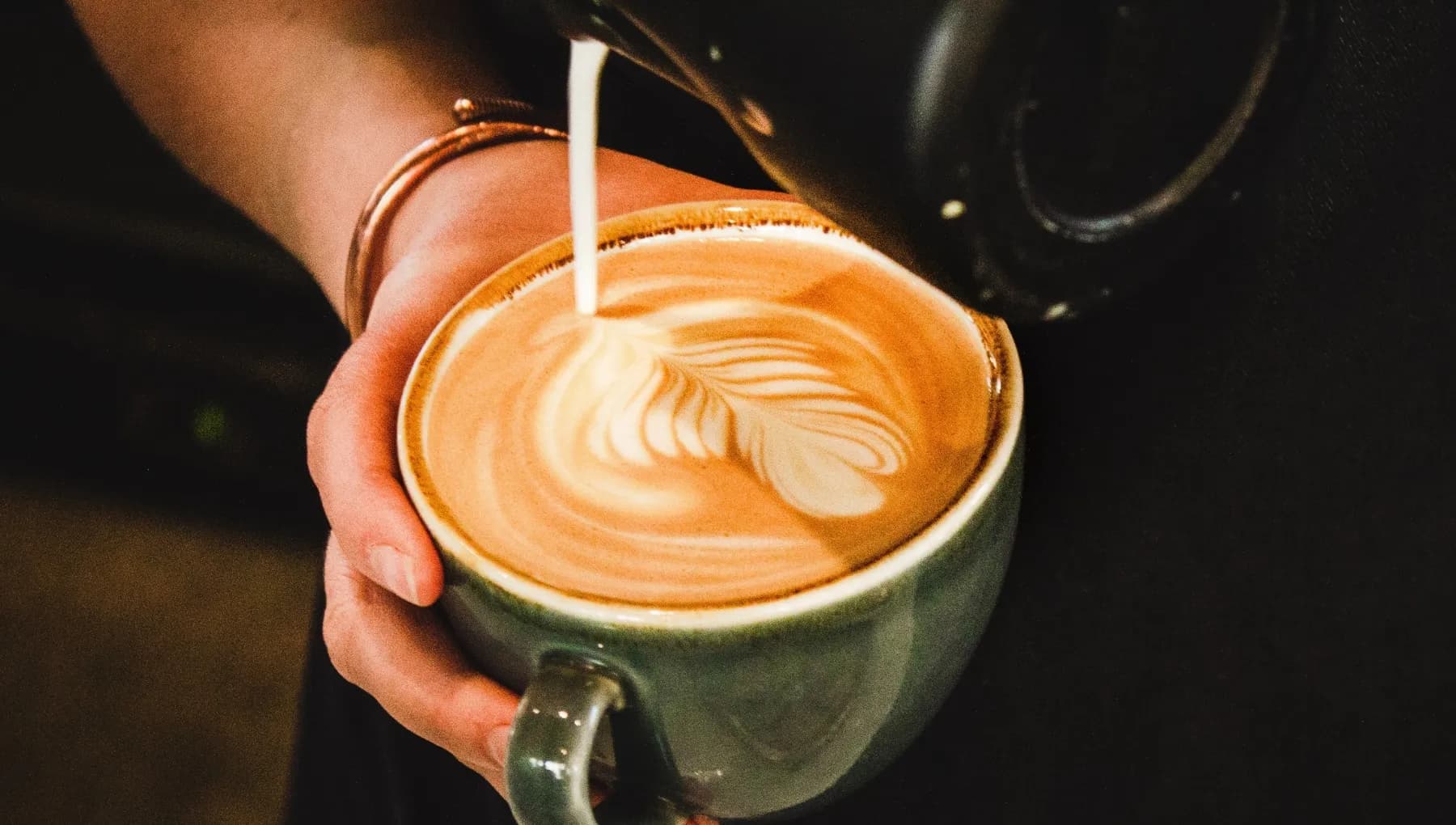 Dignita barista pouring a cup of coffee