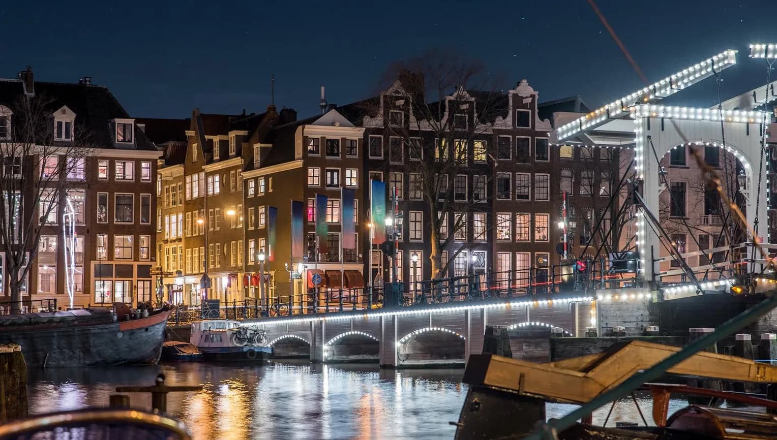 Scenic view of Amsterdam city and the river Amstel bridge at night (it's the Magere brug)
