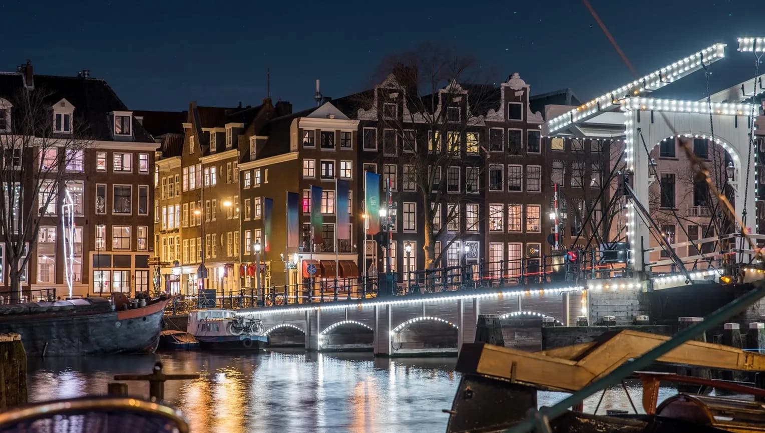 Scenic view of Amsterdam city and the river Amstel bridge at night (it's the Magere brug)
