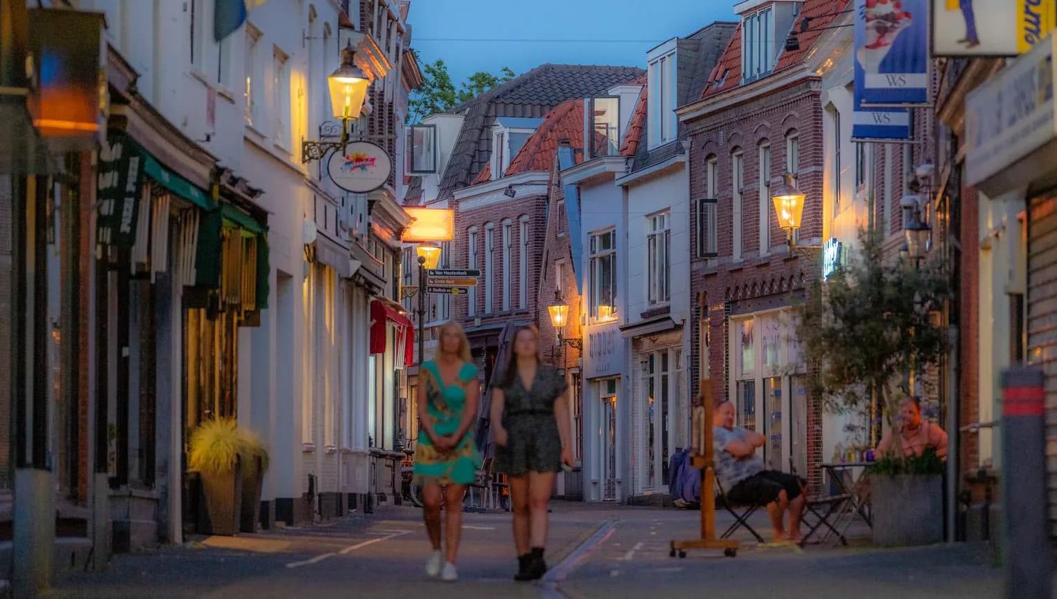 People walking through the streets of Weesp at night
