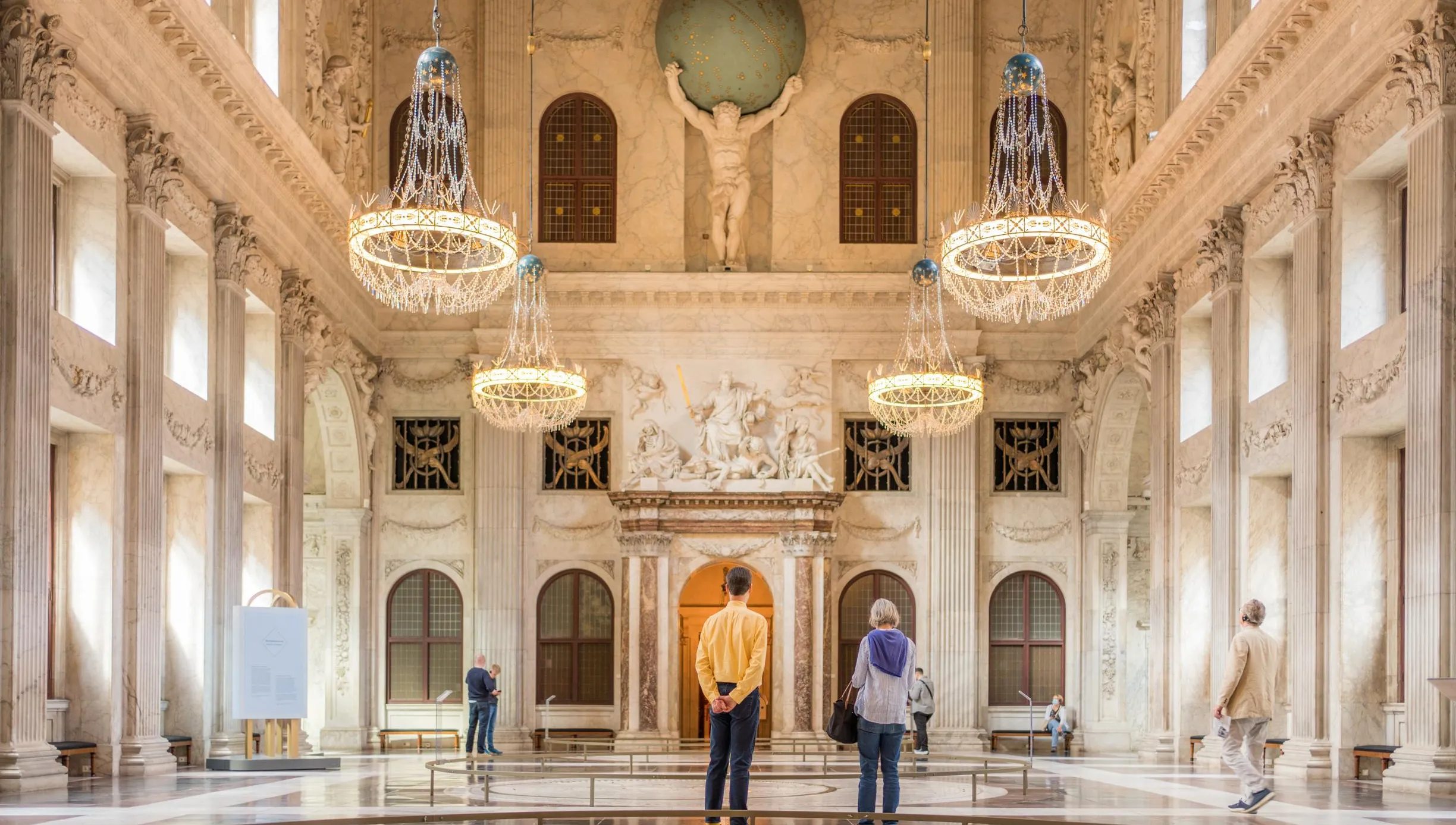 People wandering through the Royal Palace at Dam Square. Koninklijk Paleis op de Dam
