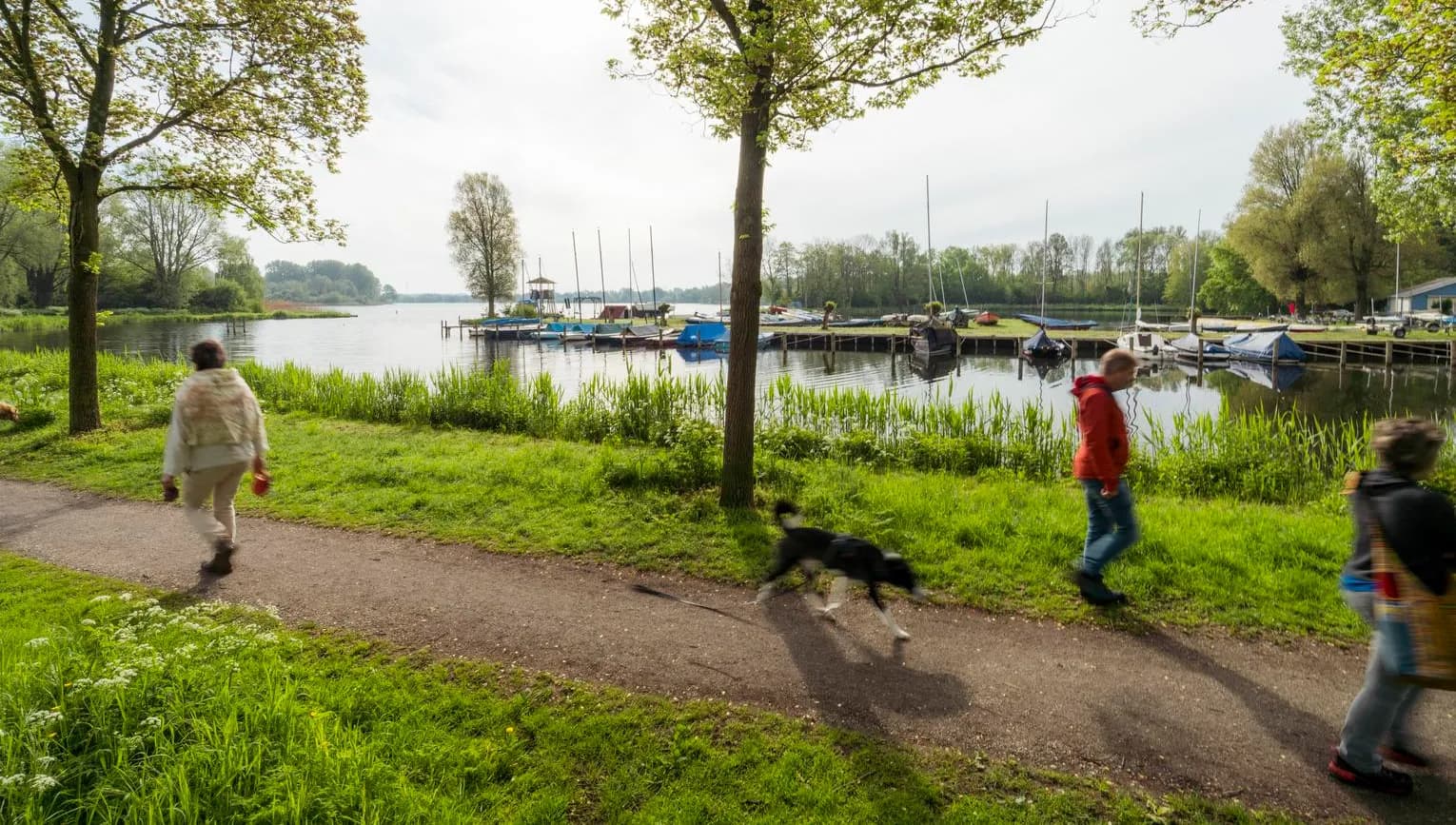 People take a walk alongside Gaasperplas.