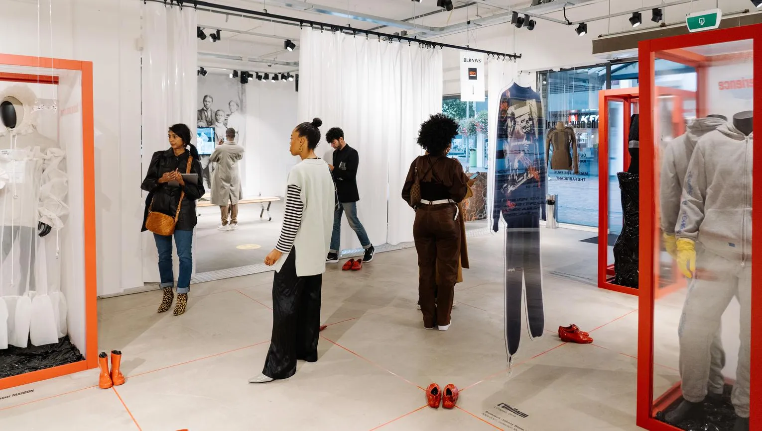 People looking at clothes at the new normal gallery