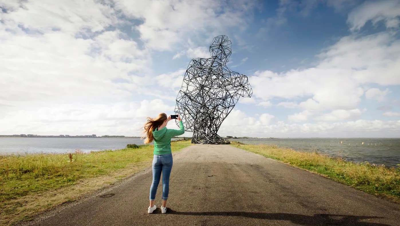 A woman making a picture of Exposure Landart Lelystad