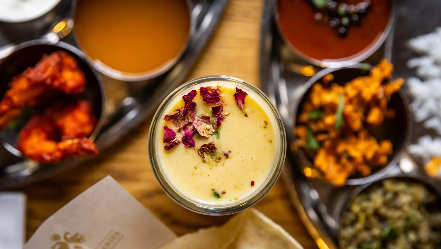 Thali of dishes and lassi drink at The Madras Diaries Indian resturant