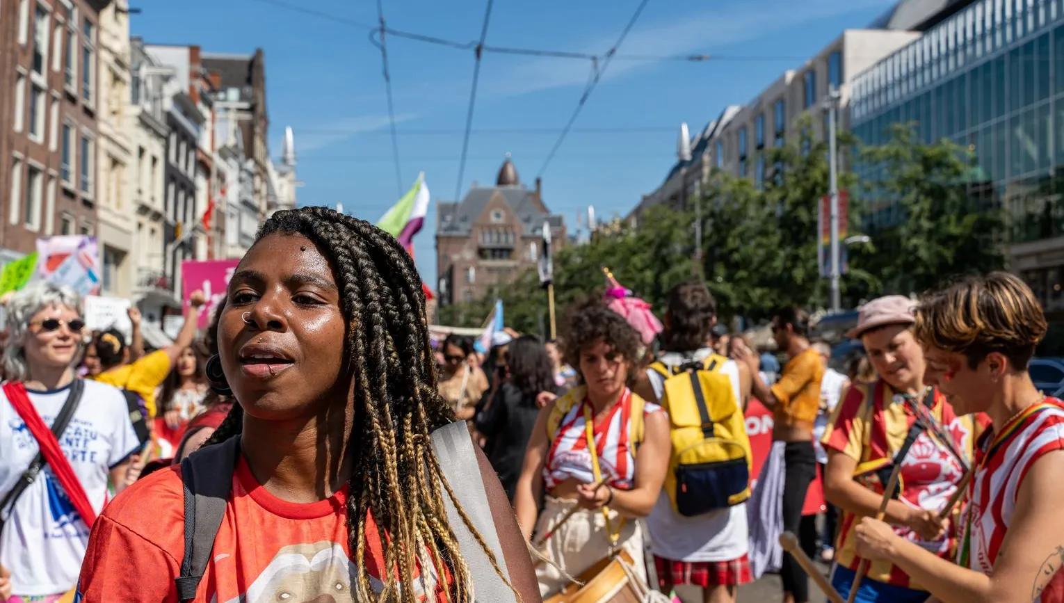A crowd of people marching - Pride Walk Amsterdam