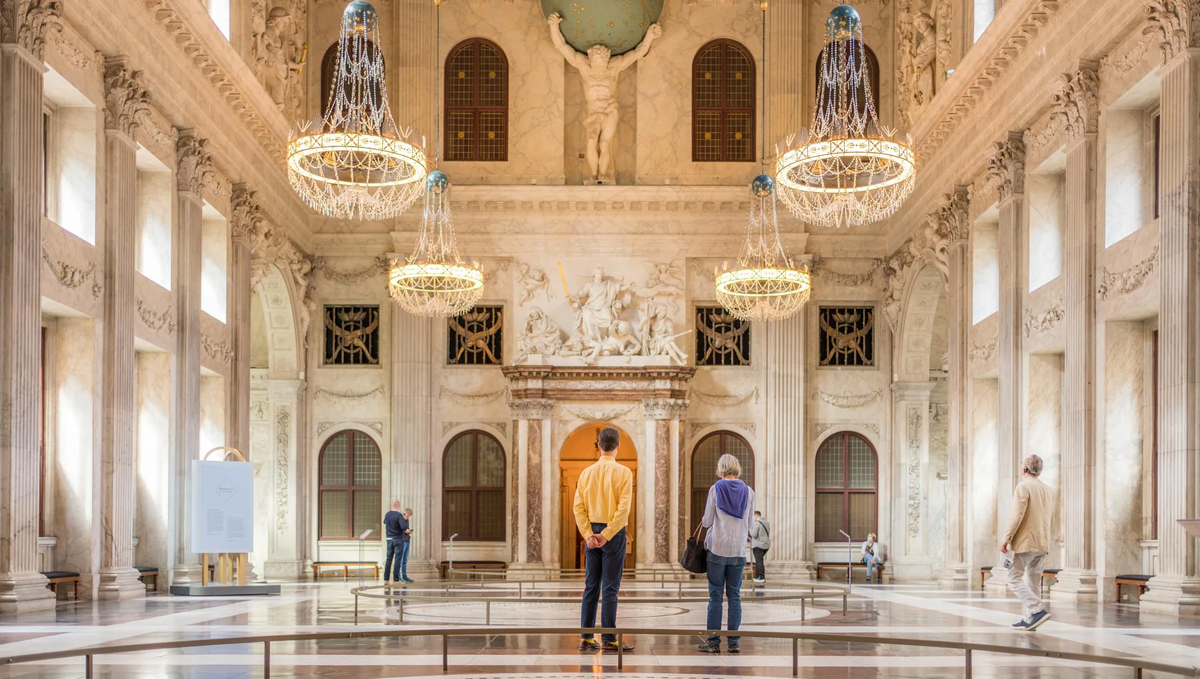 People wandering through the Royal Palace at Dam Square. Koninklijk Paleis op de Dam