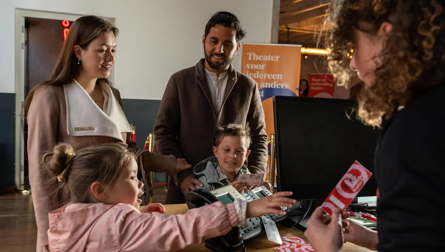A family receive tickets for a play at Theater De Krakeling