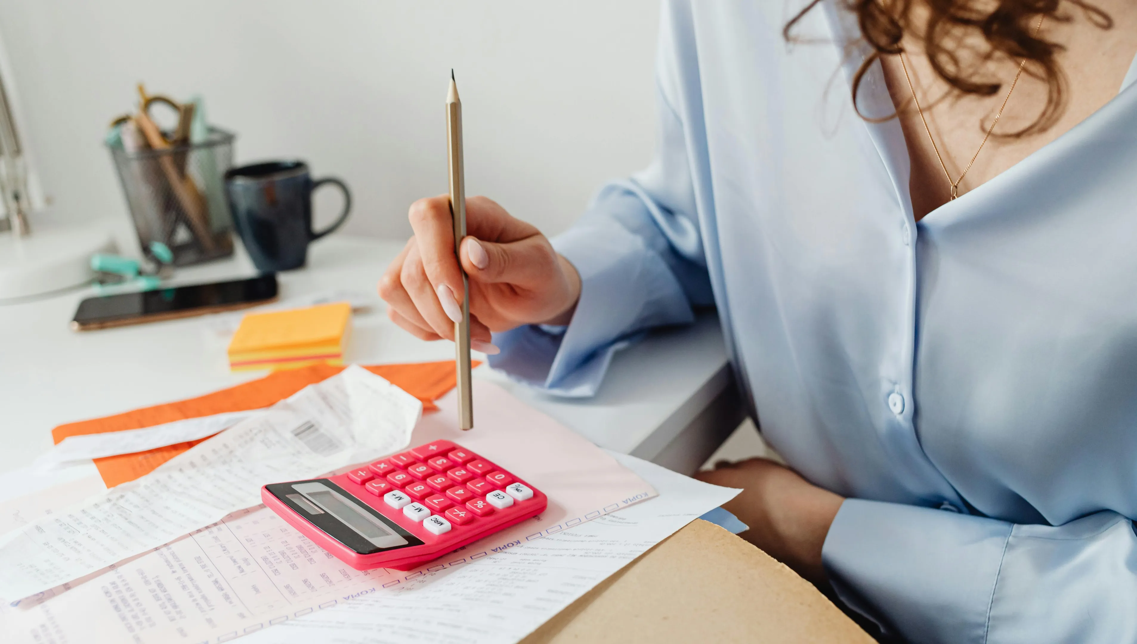 Woman in an office doing taxes and finance calculations at a desk