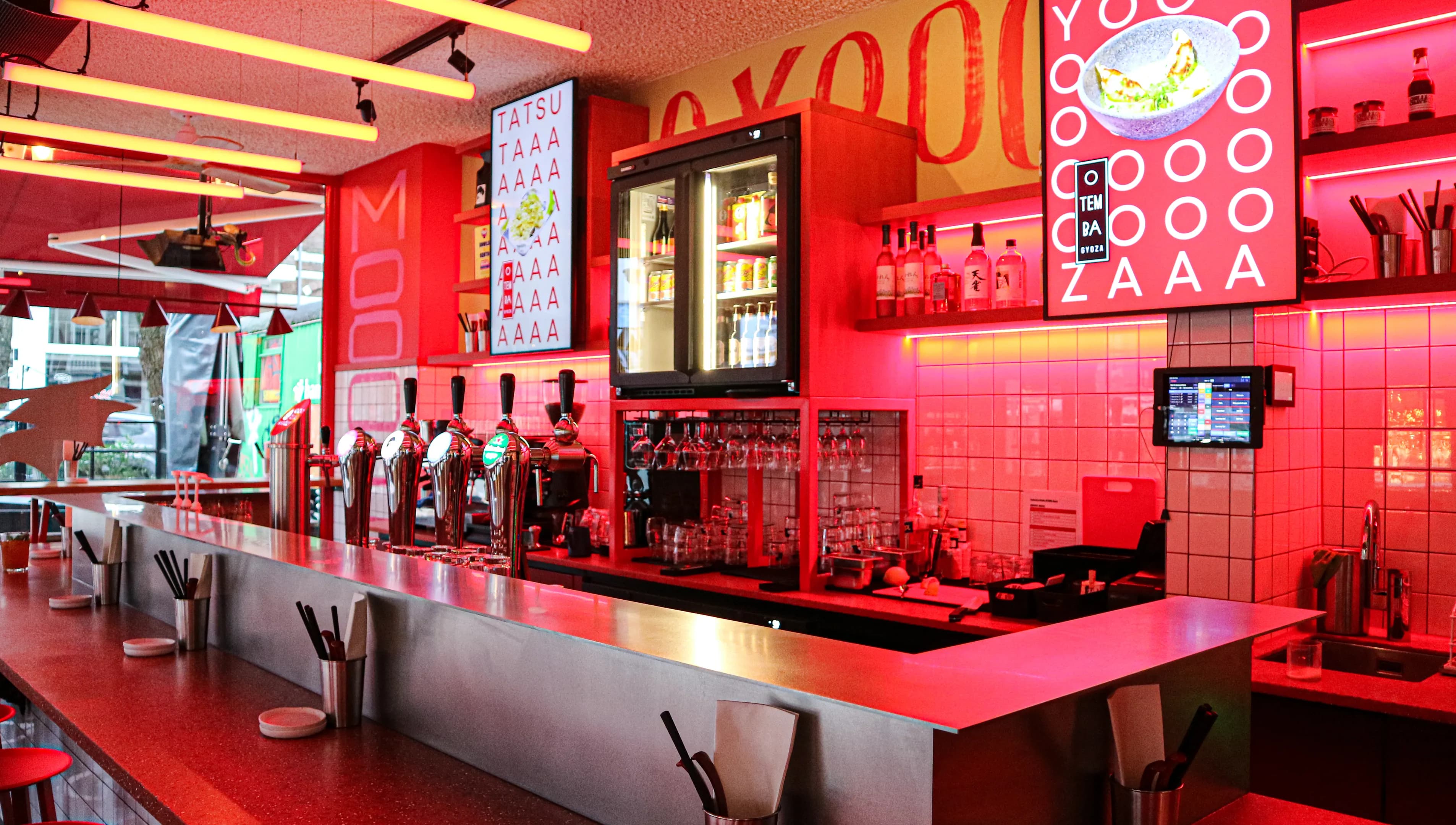Pink neon interiors of OTEMBA-gyoza Japanese restaurant on Van Woustraat in De Pijp