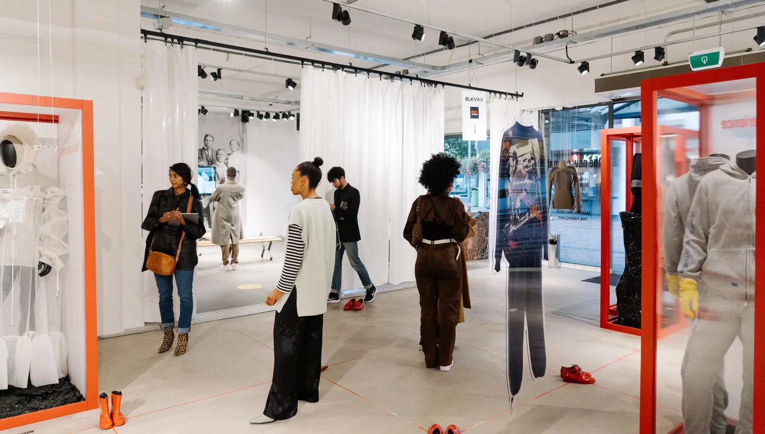 People looking at clothes at the new normal gallery