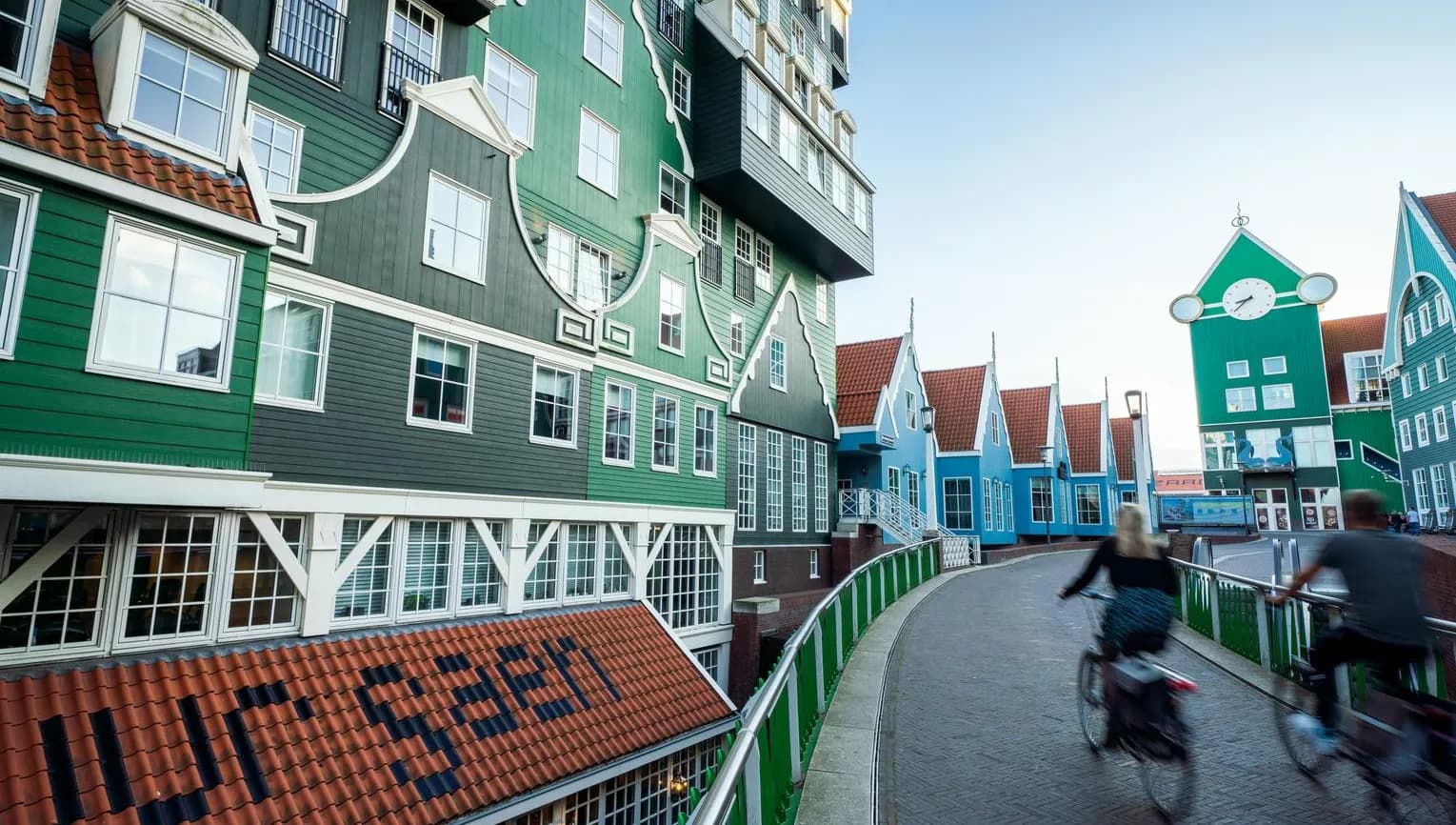 People cycling next to the iconic Zaan hotel in Zaandam
