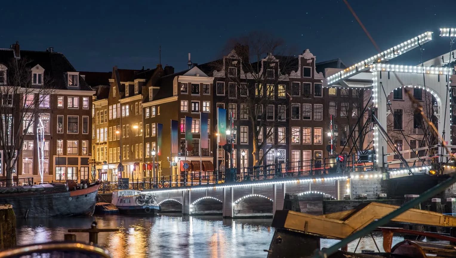 Scenic view of Amsterdam city and the river Amstel bridge at night (it's the Magere brug)