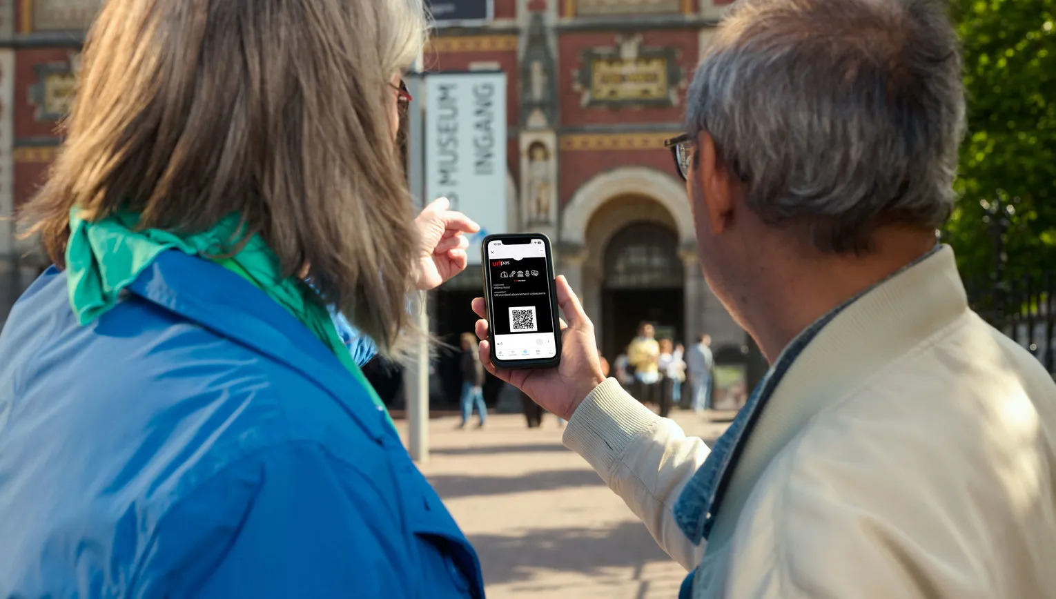 Closeup shot of the Uitpas app held by different people