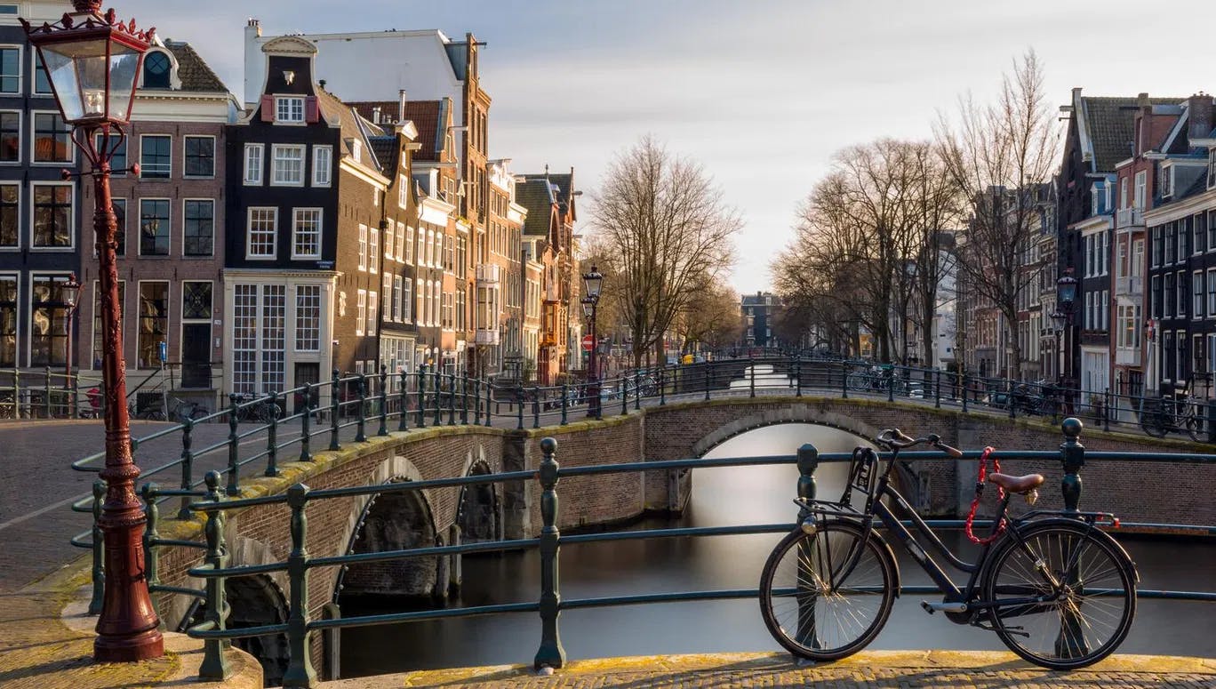 Bike parked on the bridge at Reguliersgracht in Winter